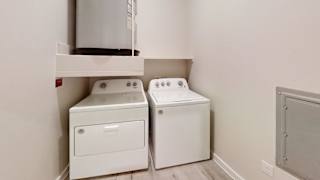 a laundry room with two washes and a dryer in it at Bridge at Speyside Apartments, Austin, TX, 78754