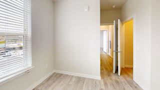 Empty bedroom with window and hallway access at Bridge at Windsor Park Apartments, Texas