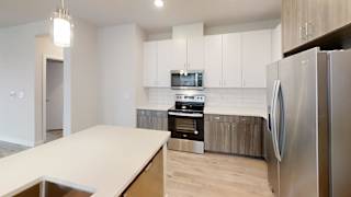 Modern kitchen with stainless appliances and subway tile at Bridge at Windsor Park Apartments, Austin, 78723