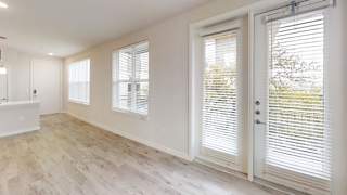 Bright living area with french doors and windows at Bridge at Windsor Park Apartments, Texas