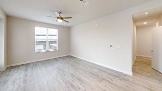 Unfurnished bedroom with ceiling fan and wood flooring at Bridge at Windsor Park Apartments, Texas, 78723