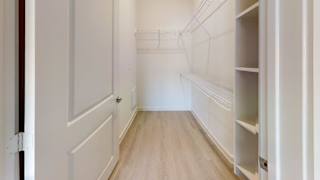 Walk-in closet with white wire shelving at Cantarra Apartments, Texas