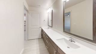 Double vanity bathroom with framed mirrors and drawers at Cantarra Apartments, Manor, 78653