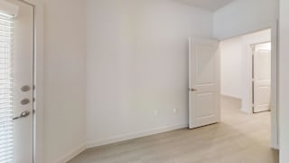 Spacious empty bedroom with adjacent hallway at Cantarra Apartments, Manor