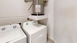 Laundry room with washer dryer and water heater 2 at Cantarra Apartments, Manor, TX 78653