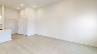 Spacious living area with vaulted ceiling and doors at Cantarra Apartments, Texas, 78653