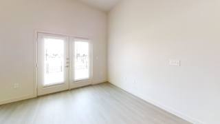 Unfurnished room with french doors and light wood floors at Cantarra Apartments, Manor, TX 78653