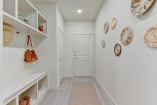 Entryway with built in storage and decorative wall accents 1 at Cantarra Apartments, Manor, 78653