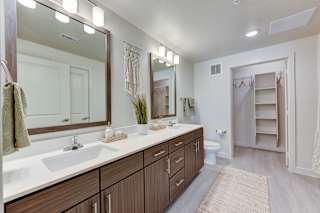 Spacious bathroom with dual vanity and walk-in closet 2 at Cantarra Apartments, Manor, TX 78653