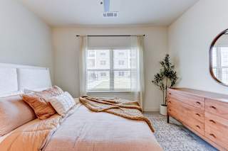 Cozy bedroom with wood dresser and soft textiles 1 at Cantarra Apartments, Texas, 78653