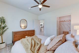 Bedroom with wooden dresser and walk-in closet 1 at Cantarra Apartments, Manor, TX 78653