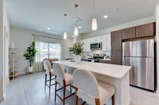 Modern kitchen with island seating and pendant lights 1 at Cantarra Apartments, Manor