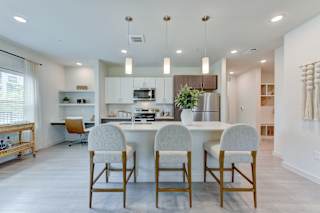 Modern kitchen and dining area with pendant lighting 1 at Cantarra Apartments, Manor, TX