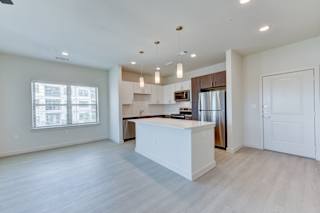 Open concept living area with kitchen island at Cantarra Apartments, Manor