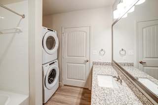 a bathroom with a washer and dryer at Avery Ranch, Texas