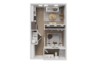 A small, neatly organized studio apartment with a bed, desk, and kitchenette.