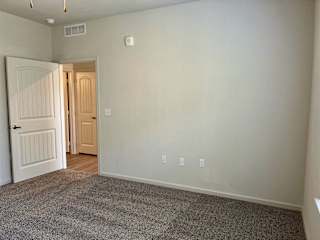 Bedroom with wooden floor at Bridge at Delco Flats Apartments, Austin