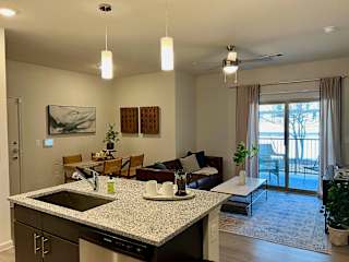 Open kitchen island overlooking living room and dining space at High Point Preserve Apartments, Austin, TX