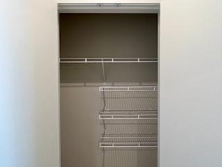 Empty closet with rod system at Bridge at Windsor Park Apartments, Texas, 78723