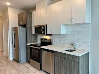 Kitchen with subway tile backsplash at Bridge at Windsor Park Apartments, Austin, 78723