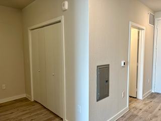Hallway with closets and central utility access panel at Bridge at Windsor Park Apartments, Austin, TX 78723
