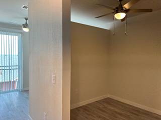 Empty alcove area with ceiling fan and wood flooring at Bridge at Windsor Park Apartments, Austin, TX