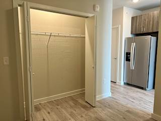 Empty closet with wire shelving near modern kitchen at Bridge at Windsor Park Apartments, Austin