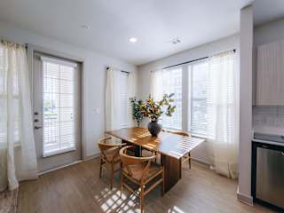 A kitchen with a table and chairs in the middle of the room.