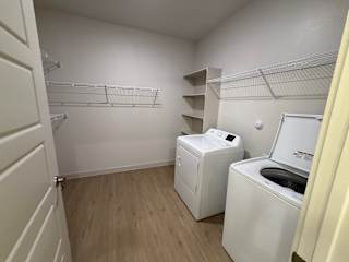 A small laundry room with a washer and dryer.