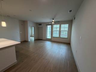 A room with wooden floors and a ceiling fan.