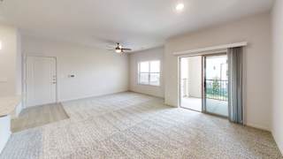 an empty living room with a sliding glass door and a ceiling fan at Avery Ranch, Austin