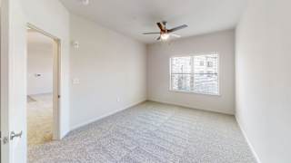 a bedroom with white walls and a ceiling fan at Avery Ranch, Austin Texas