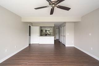 a bedroom with hardwood floors and a ceiling fan at Hillside Apartments, Wixom, Michigan