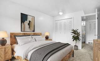 A bedroom with a large bed and closet  at Apple Ridge Apartments, Walker, MI
