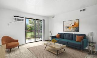 A living room with a slider to a balcony  at Apple Ridge Apartments, Walker, MI