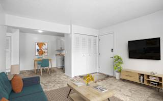 A dining and living room with carpeting  at Apple Ridge Apartments, Walker, MI