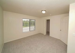 an empty living room with a window and a door  at Arbor Lakes Apartments, Elkhart, IN, 46516
