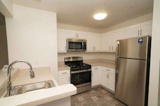a kitchen with stainless steel appliances and white cabinets  at Arbor Lakes Apartments, Indiana