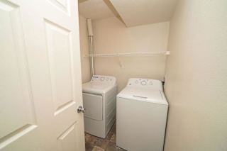 a washer and dryer in a room with a door  at Arbor Lakes Apartments, Elkhart, IN, 46516