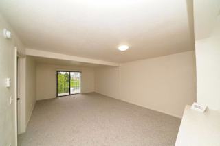 an empty living room with a sliding glass door  at Arbor Lakes Apartments, Elkhart, IN, 46516