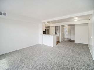a dining room with plush carpeting at Black Sand Apartment Homes in Lincoln, NE