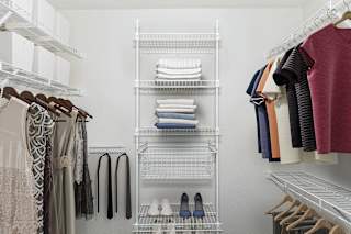 Walk-in closet with wire shelving and storage tower at Black Sand Apartments Homes, Nebraska
