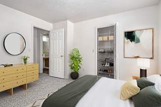 Bedroom with organized closet and natural light at Brentwood Park Apartments, La Vista, NE 68128