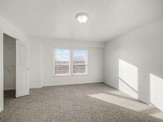 Spacious bedroom with walk-in closet and windows at Brentwood Park Apartments, La Vista, NE