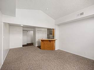 Open living area with kitchen breakfast bar at Brentwood Park Apartments, Nebraska