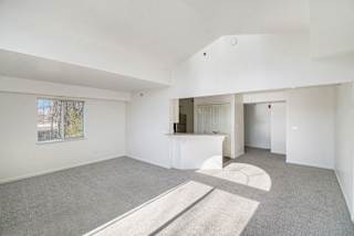 Spacious room with kitchen passthrough and vaulted ceiling at Brentwood Park Apartments, La Vista, 68128