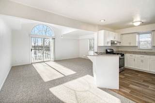 Open living area with arched door and kitchen peninsula at Brentwood Park Apartments, Nebraska, 68128