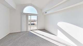Bright living room with balcony access and vaulted ceiling at Brentwood Park Apartments, La Vista, NE 68128