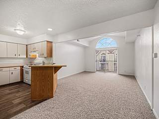 Open concept kitchen and living space with peninsula bar at Brentwood Park Apartments, La Vista, NE