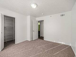 Empty bedroom with walk-in closet and open doorway at Brentwood Park Apartments, La Vista, NE 68128